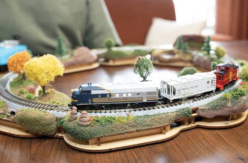 Build A Scene Product Image - N Scale train running around a series of crafted micro-scenese