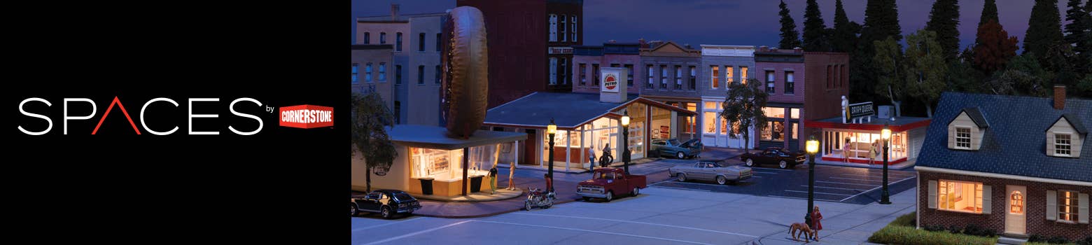 Spaces by Cornerstone logo and background image of a downtown scene at dusk